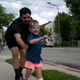 Nova, 5, races with their parent, Flowers, on the way to the park in Evanston.
